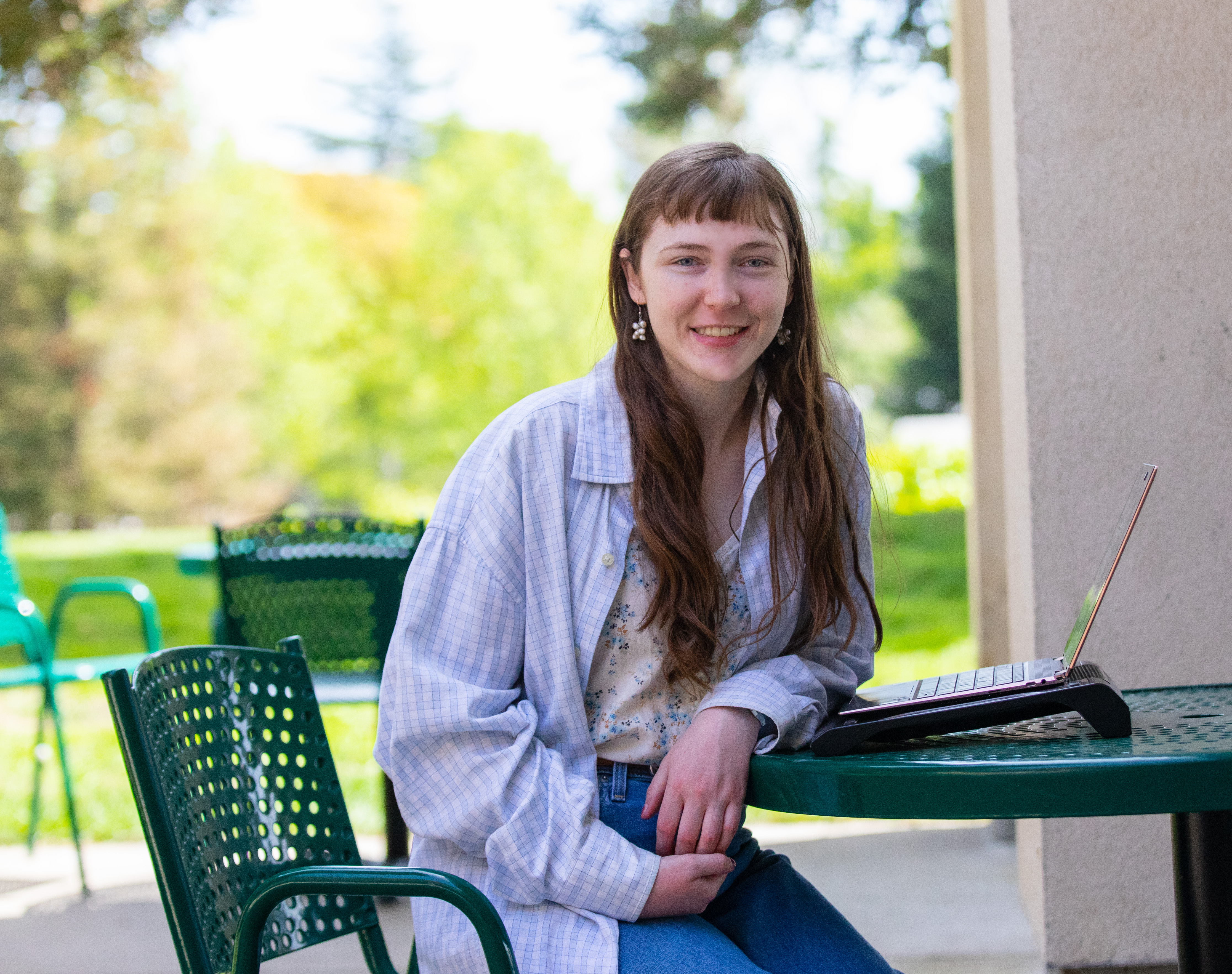 Headshot of Grey at their computer